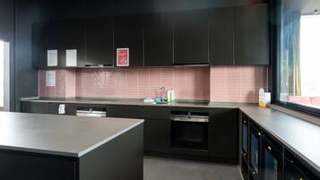 Fridge, microwave, coffee/tea maker, cookware/dishes/utensils