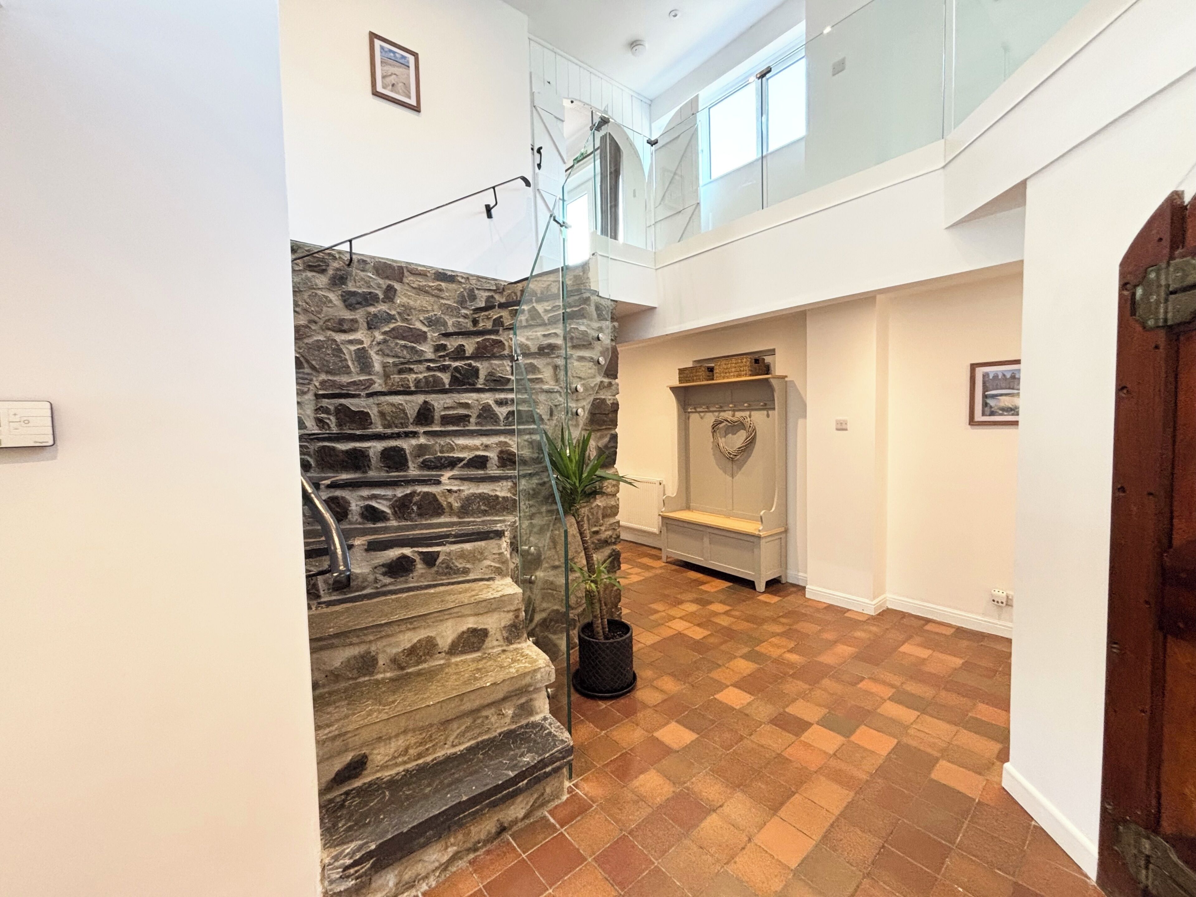 A staircase with stone steps, a wooden door, and a bench with a heart-shaped decoration.