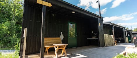 A wooden building with a sign indicating 'Jollis White B1-B16'.