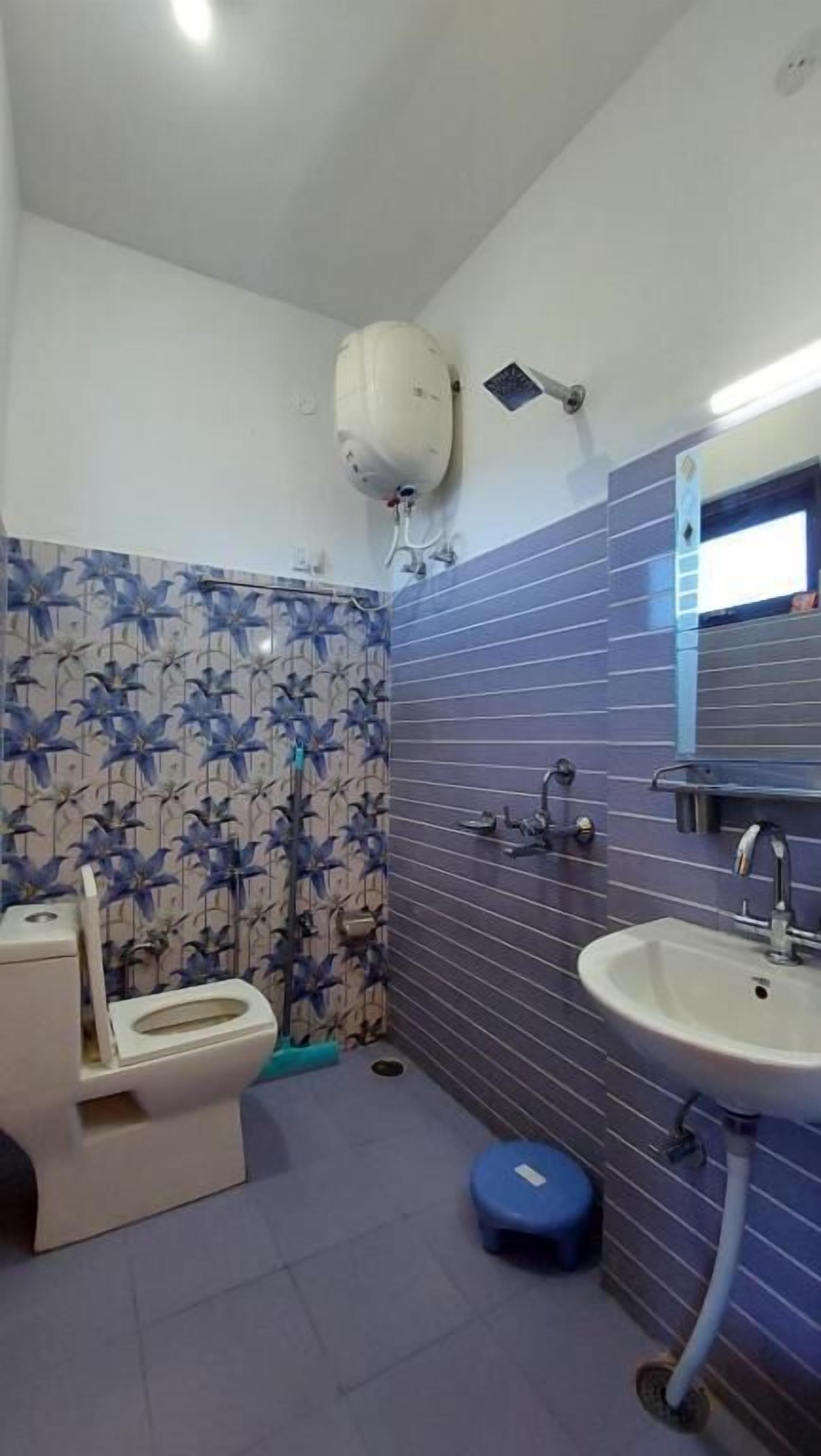 A bathroom with a toilet, sink, and shower.