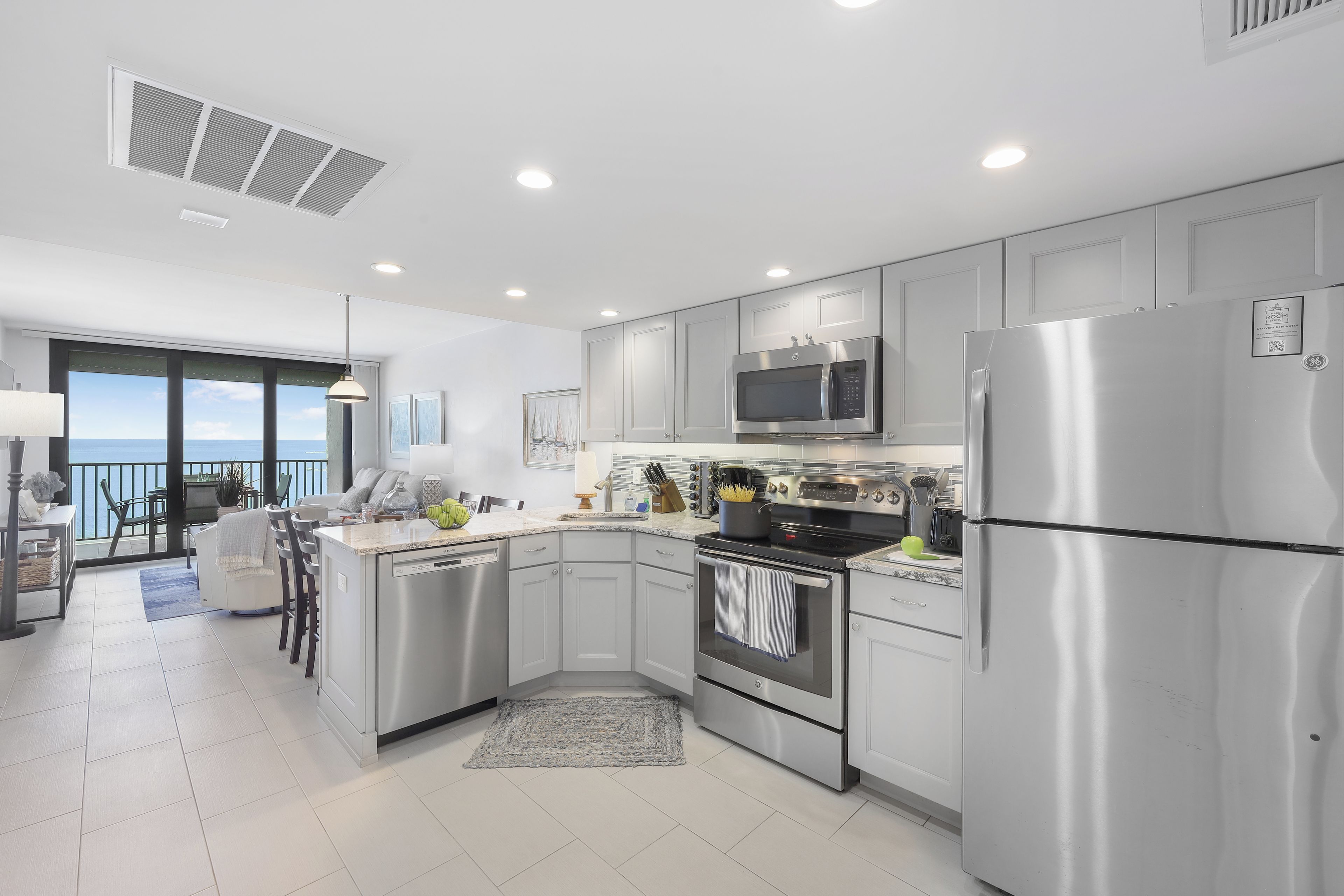 A modern kitchen with stainless steel appliances, a built-in oven, and a microwave.