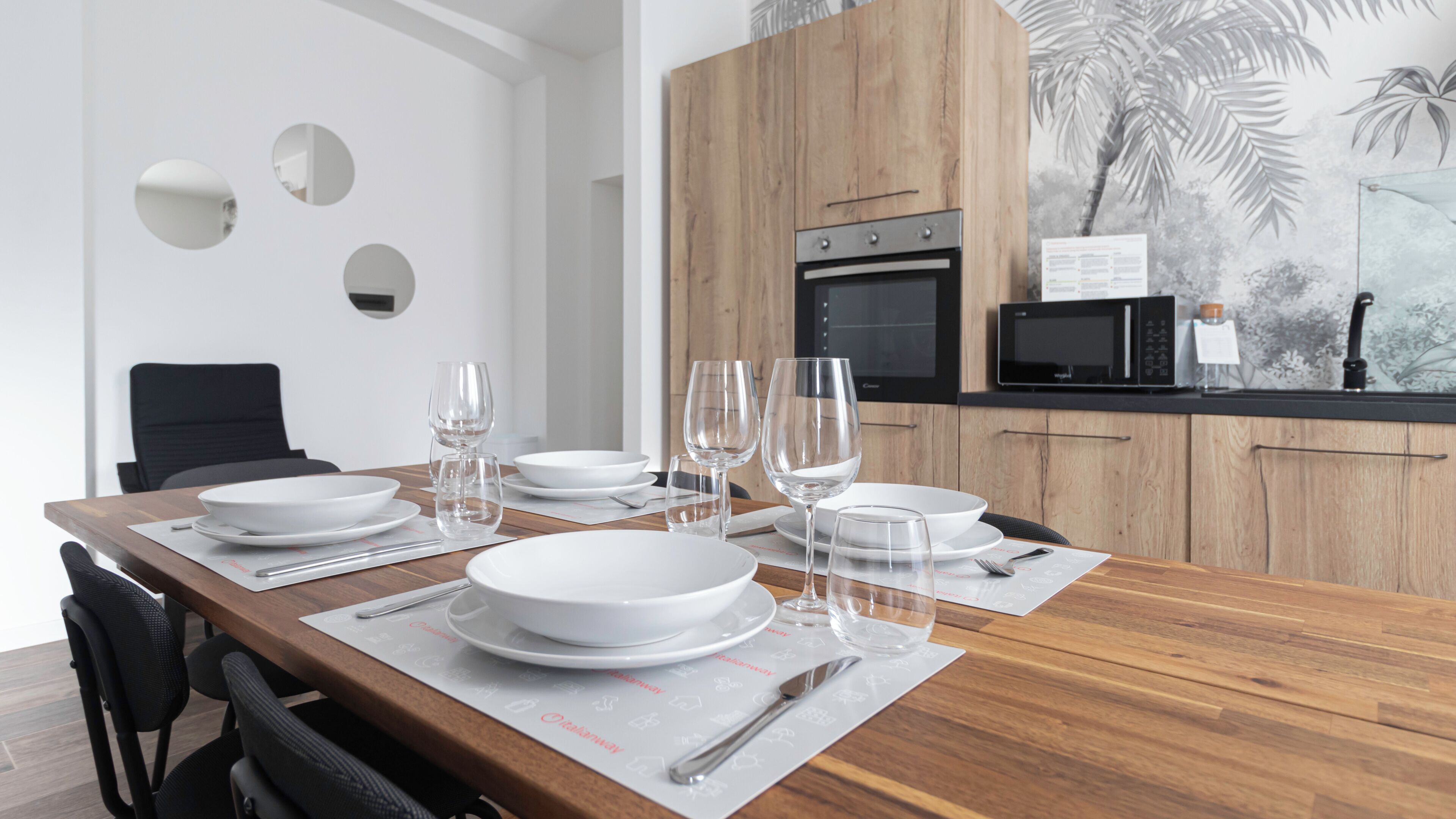 A modern kitchen with wooden cabinets, a microwave, and a stove.