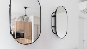 A modern kitchen with wooden cabinets, a built-in oven, and a pendant light. - Italianway Comfort - Buenos Aires 65 E (Milan)
