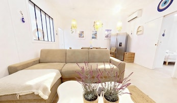 MYKONOS | Living area | 107-cm flat-screen TV with cable channels, Netflix, pay movies