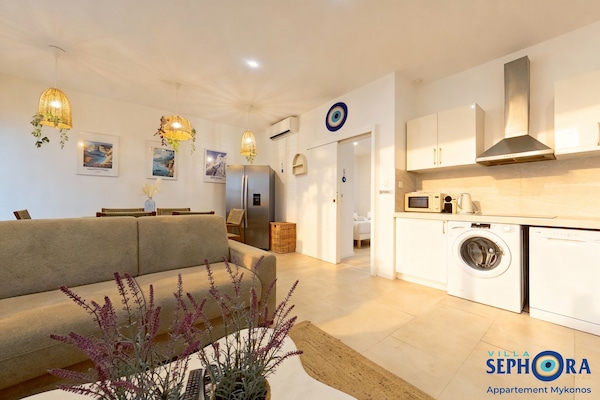 MYKONOS | Living area | 107-cm flat-screen TV with cable channels, Netflix, pay movies