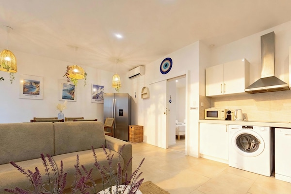 MYKONOS | Living area | 107-cm flat-screen TV with cable channels, Netflix, pay movies