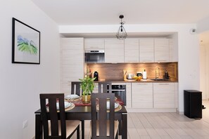 Enjoy cooking in this well-equipped kitchen with a central island, oven, microwave, and sink.