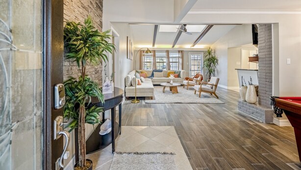 A spacious living room with a fireplace, a sofa set, and a pool table. - Modern Home with Private Pool, Minutes to NRG & Med Center (Houston)