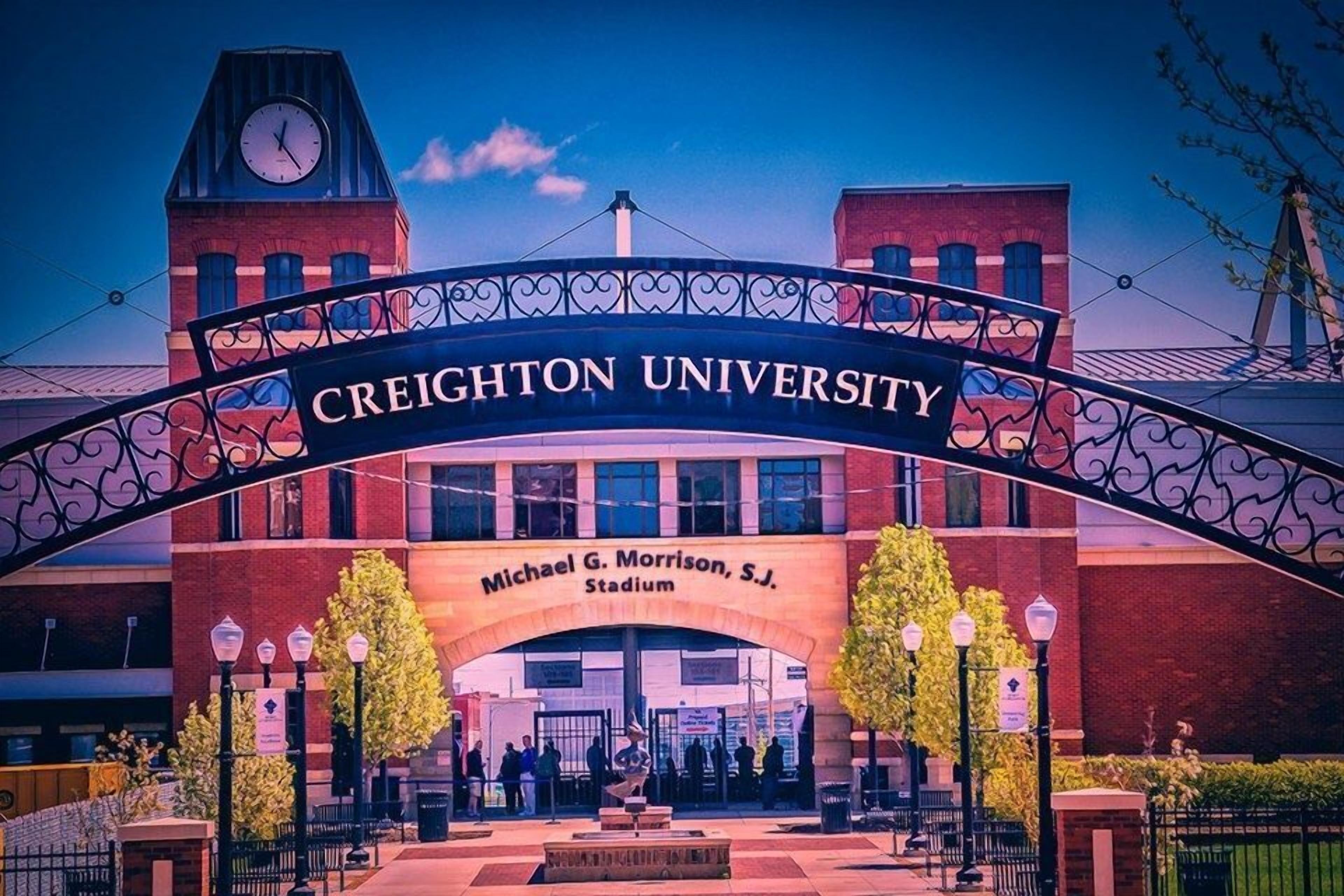 The entrance to Creighton University, featuring a prominent archway with the university's name and the Michael G. Morrison, S.J. Stadium.