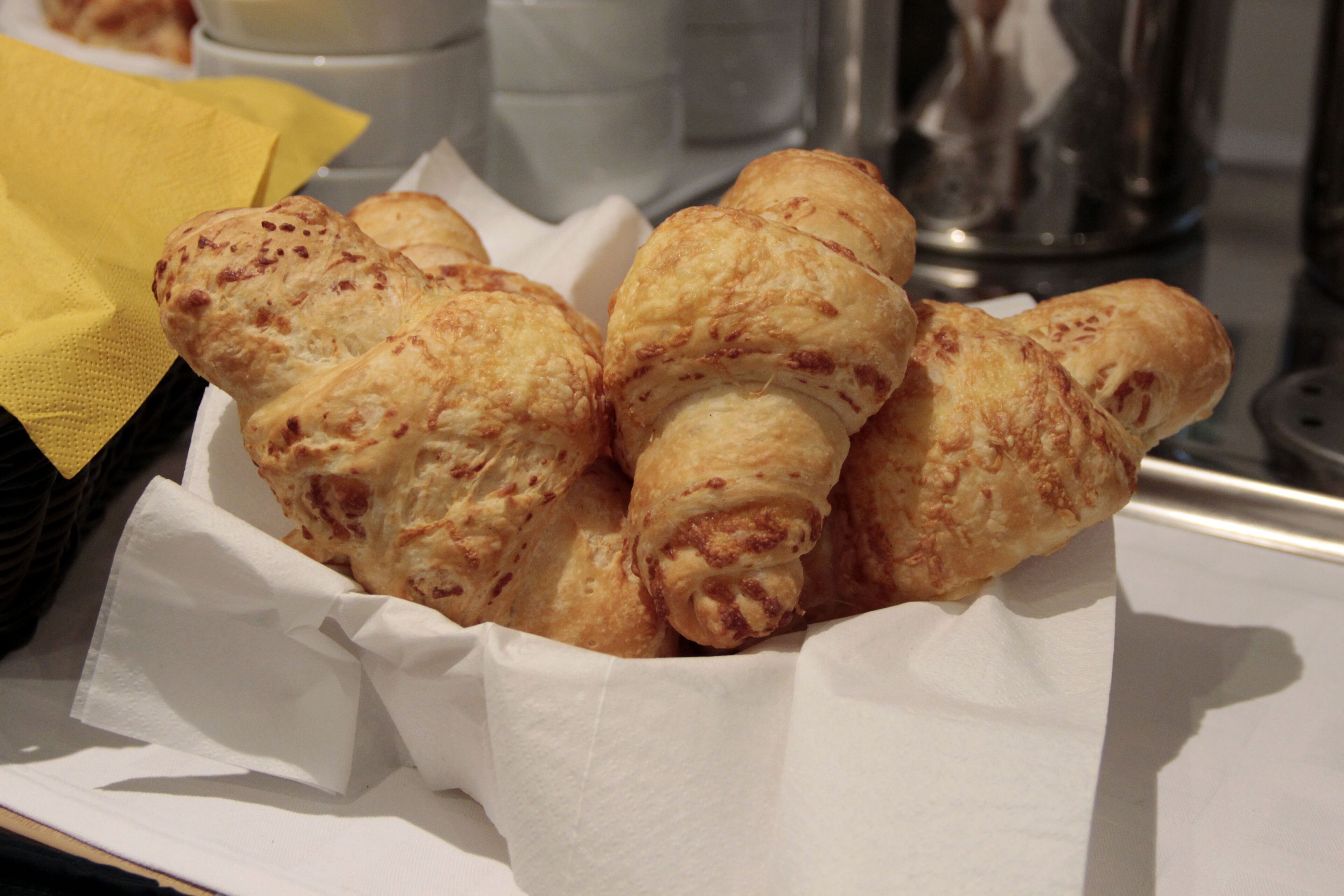 A basket of croissants on a tray.