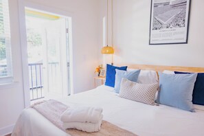 A hotel room with a bed, a window, and a framed picture on the wall. - The Champion's Suite. New Build, Upscale, Central (Gainesville)