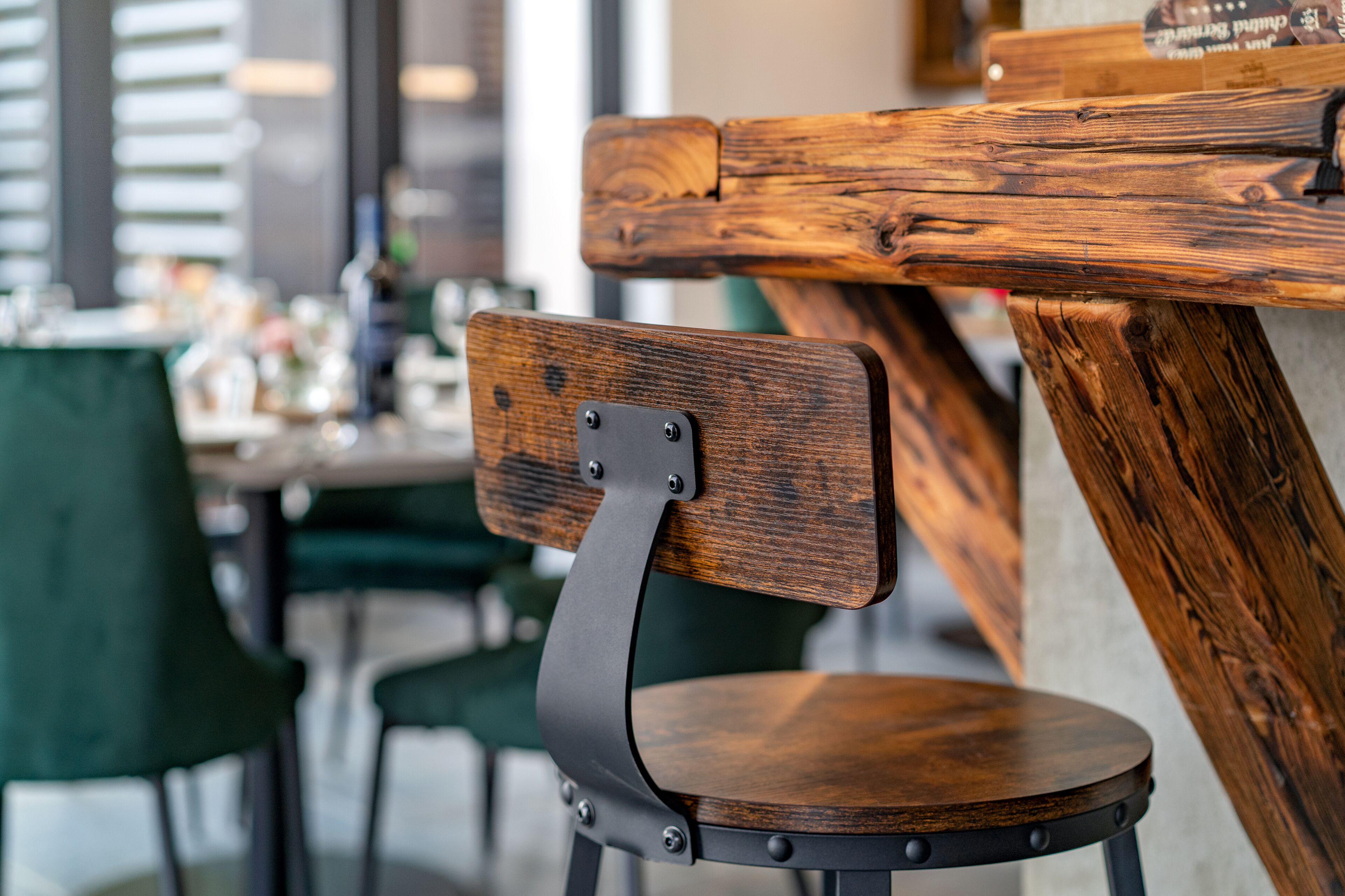 A wooden chair with a metal backrest and a round wooden seat.