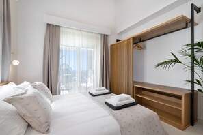 A modern hotel room with a large bed, a wooden console table, and a large window with curtains. - Villa Athena luxury Villa,Vamos,13.5/5m Swimming pool,floodlit Pickleball court (Vamos)