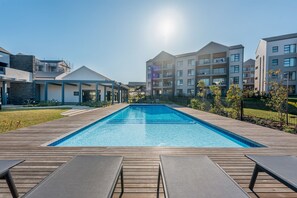 Relax by the central pool surrounded by lounge chairs and take in the views from the upper floors.