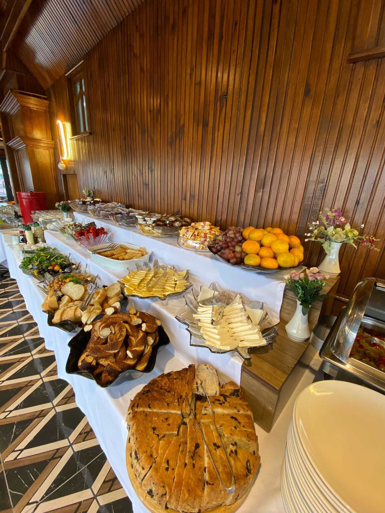 A buffet table with various food items and a cake.