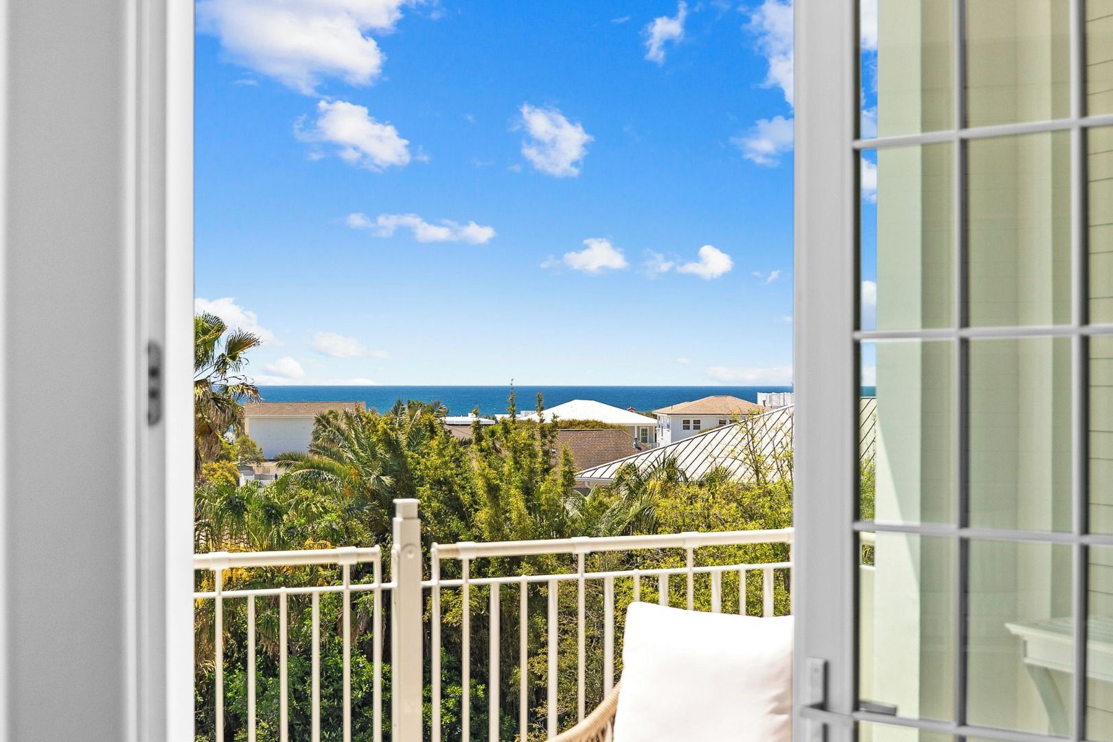 Ein Balkon mit Blick auf das Meer und Gebäude.