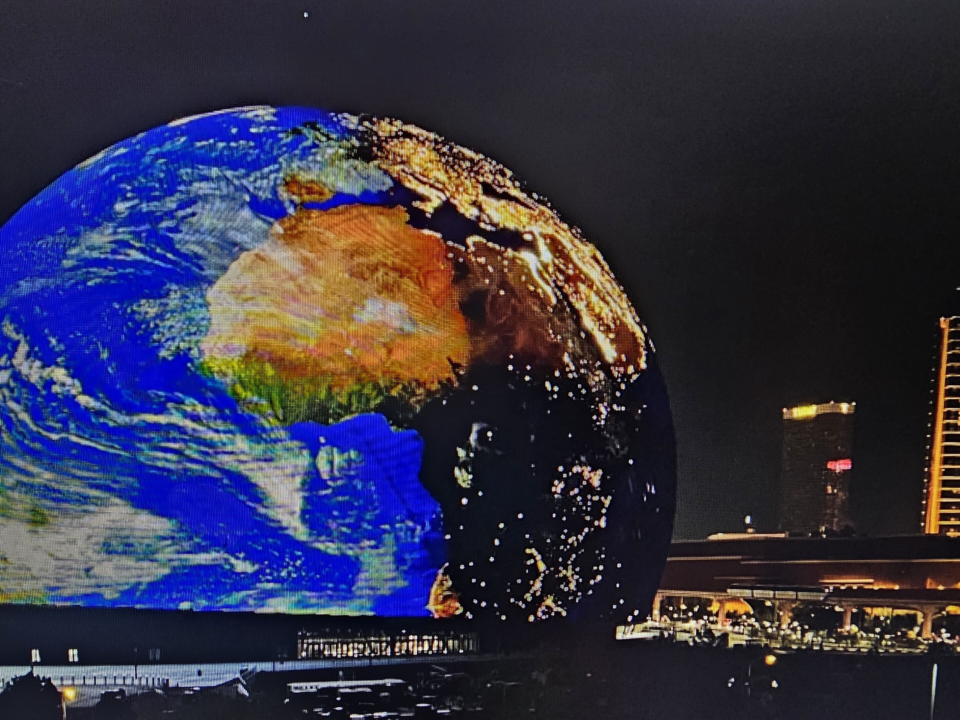 A large globe display with a cityscape in the background.