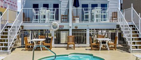 Een buitenzwembad, ligstoelen bij het zwembad