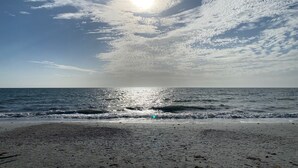A beach with a clear sky, ocean waves, and a sandy shore. - Fantastic Ft Myers Beachfront Condo! Flexible Check-in Dates and many amenities! (Fort Myers Beach)