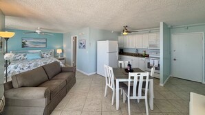 A compact living space with a kitchenette, a dining area, and a bedroom. - Fantastic Ft Myers Beachfront Condo! Flexible Check-in Dates and many amenities! (Fort Myers Beach)