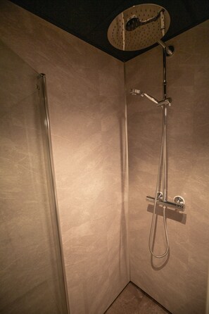 Enjoy a refreshing shower experience with a handheld and overhead showerhead.