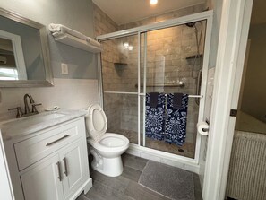 Shower, hair dryer, towels, toilet paper