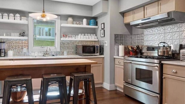 A modern kitchen with a large island, stainless steel appliances, and a view of the outdoors. - Berkshire House Stay: 5BR/5BA (Lee)
