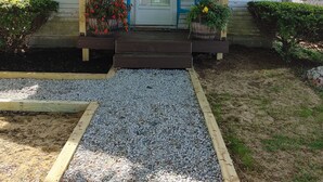 A white building with a sign reading "WORTH THE WAIT" and the number 45. - A Dennis Port gem-just steps to the beach! Totally remodeled top to bottom!    (Dennis)