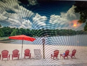A beach scene with a row of red chairs and a red umbrella, a wooden post, and a sunset in the background.