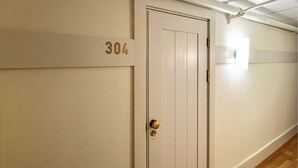 A beige door with the number 304 on the wall beside it.