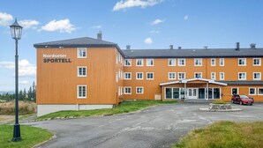 A Nordceter Sportell building with a large entrance and a parking area.