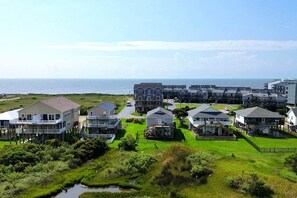 A coastal residential area with houses featuring balconies and waterfront views.