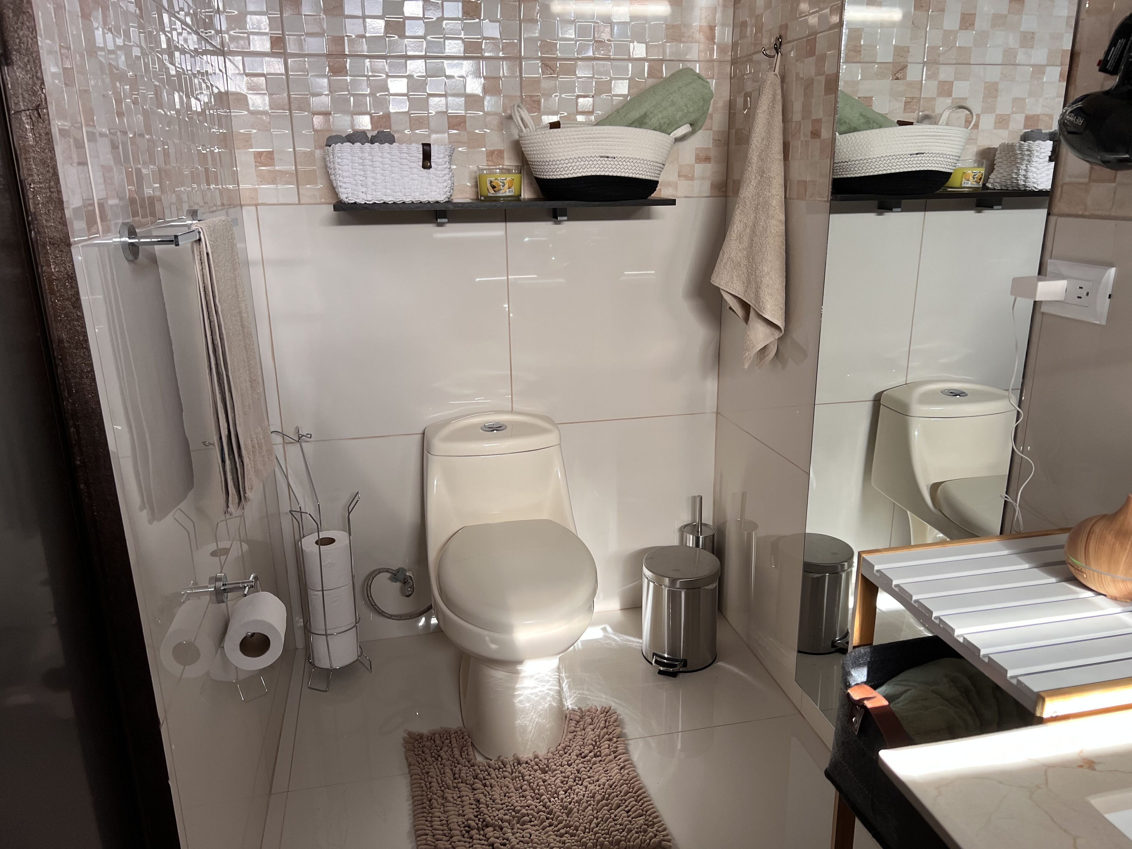 A modern bathroom with a toilet, bidet, and a mirror.