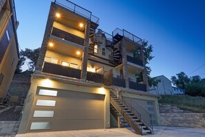 A multi-story residential building with a garage, staircases, and balconies. - Chipmunk Complex (Colorado Springs)
