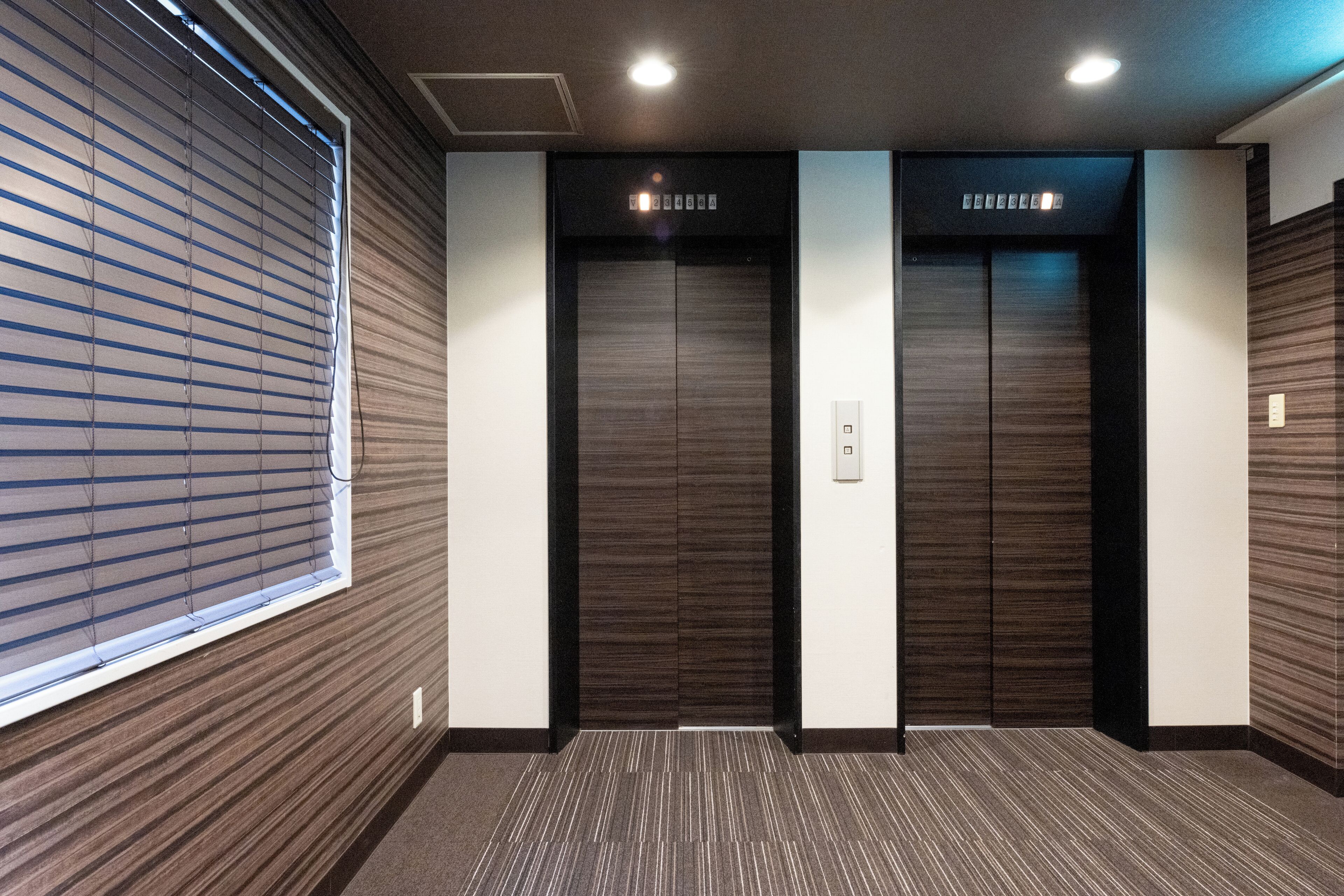An elevator with a modern design, featuring a control panel and a digital display.