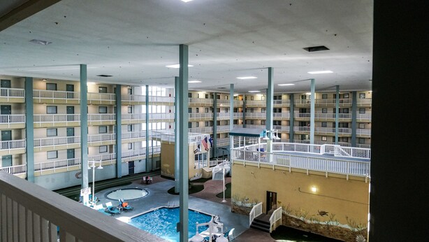A multi-level indoor swimming pool with multiple balconies and a central pool area. - Just a walk to the beach, centrally located, multiple pools, family friendly. (Hilton Head Island)