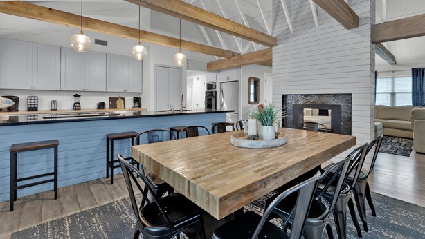 A spacious kitchen with a wooden island, bar stools, and pendant lighting. - Private Home w/Private pool1/2 block from Beach! Stylish Interior! Dog friendly! (South Padre Island)