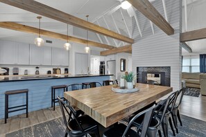 A spacious kitchen with a wooden island, bar stools, and pendant lighting. - Private Home w/Private pool1/2 block from Beach! Stylish Interior! Dog friendly! (South Padre Island)