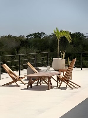 A rooftop terrace with a table and four wooden chairs, surrounded by a metal railing. -  Seremonia Origen By Zamaia Tulum (Tulum)