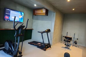 A gym with exercise equipment including a treadmill, elliptical, and weights. -  Seremonia Origen By Zamaia Tulum (Tulum)