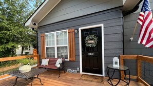 A house with a dark grey exterior, a black front door with a wreath, and an American flag. - Lovely Pet Frendly Home by Sherman (Boiling Springs)