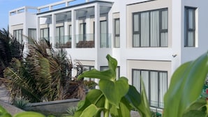 A modern multi-story hotel with large windows and balconies. - BO BIEN VANG HOTEL (Tan Thanh)