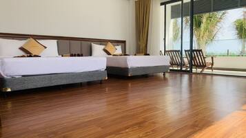 Deluxe Quadruple Room, 2 Queen Beds, Ocean View | Minibar, desk, free WiFi, bed sheets