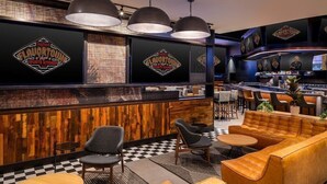 A sports-themed restaurant interior with a bar, seating area, and checkered floor. - Suite + Connecting Room at a 4⭐️ Hotel (Las Vegas)