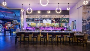 A bar area with multiple screens displaying sports events, a bar counter, and several chairs. - Suite + Connecting Room at a 4⭐️ Hotel (Las Vegas)