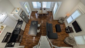 A spacious loft apartment with a kitchen, dining area, and seating space.