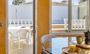 A balcony with a table set for breakfast, including croissants and a coffee pot. - Villa PINK VILLACOSTA (Torrevieja)