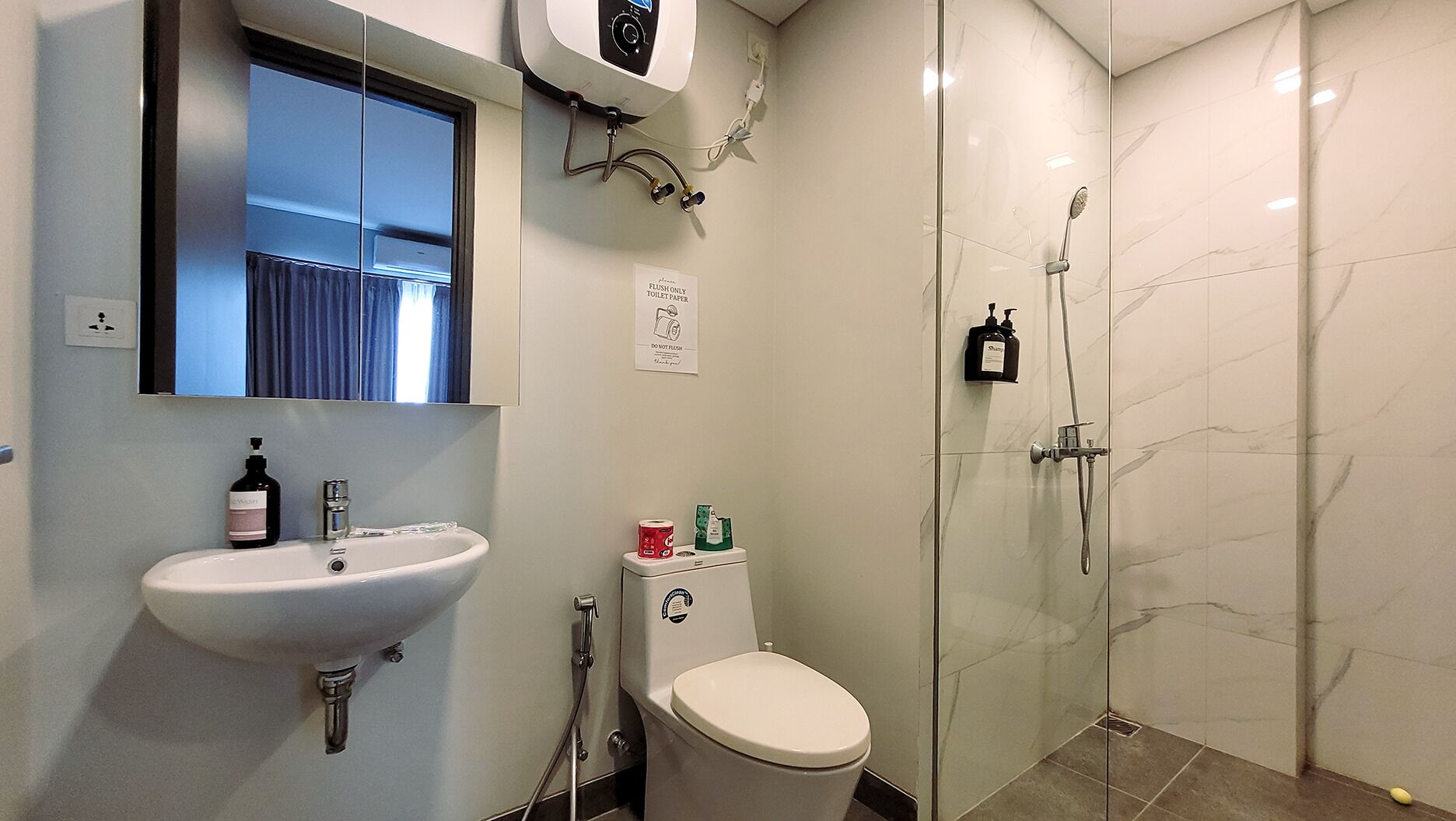 A bathroom with a sink, toilet, and shower.