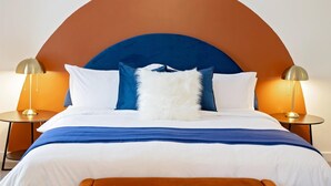 A bed with a curved headboard, two bedside tables with lamps, and a fluffy white pillow. - Newly Built Bloomington Oasis: 4bd/2.5br & Backyard, 10mins to IUB & Downtown (Bloomington)