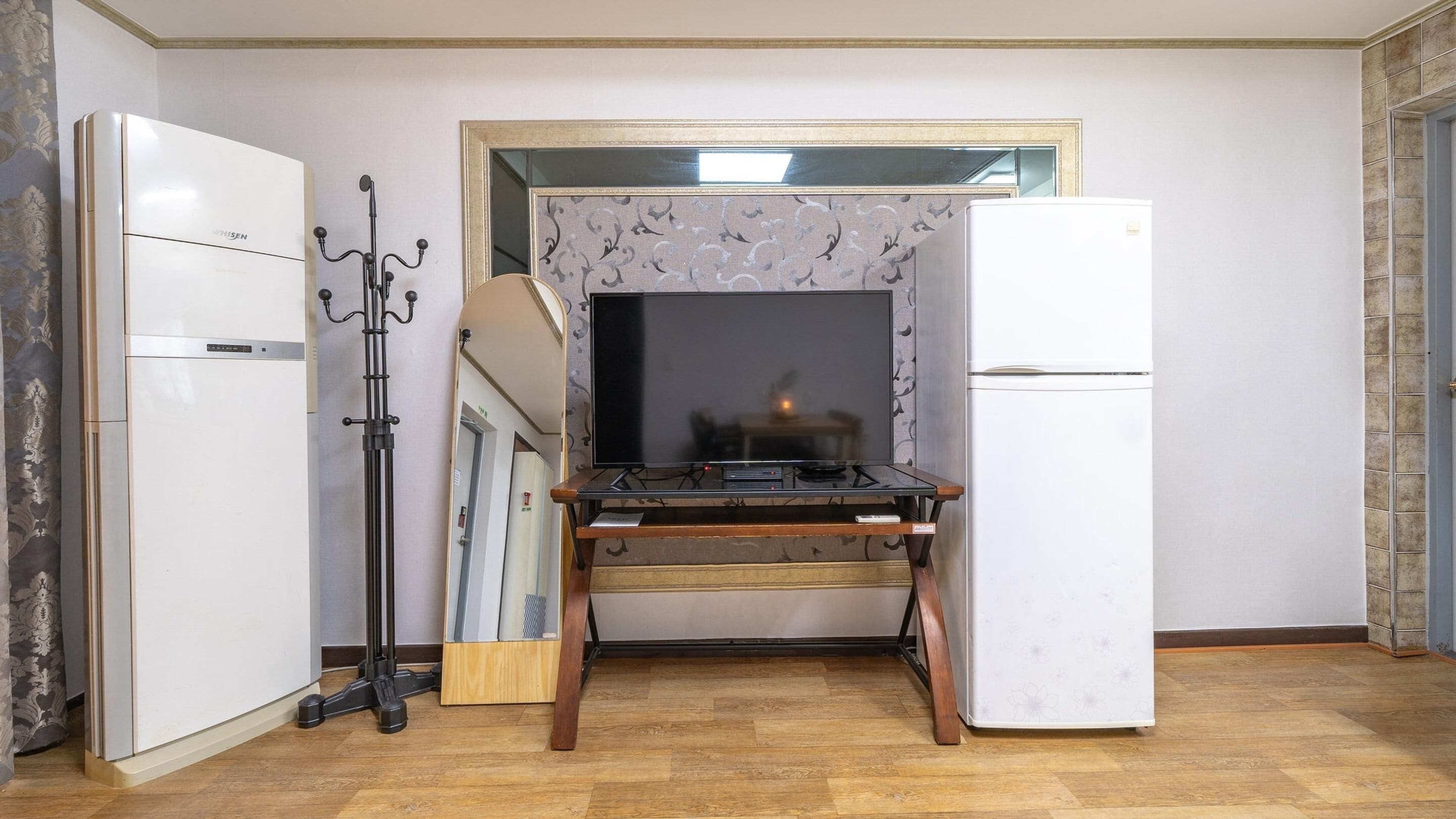 A compact kitchen with a refrigerator, a stove, and a microwave.